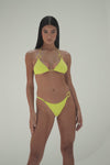 Model in gold triangle bikini top