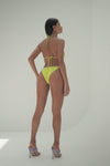 Model in gold tanga  bikini bottoms