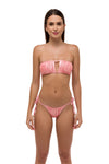 Model in pink metallic ruched bikini bottoms