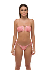 Model in pink metallic ruched bikini