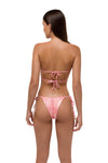 Model in pink metallic ruched bikini bottoms