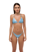 Model in blue metallic bikini top